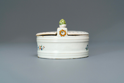A polychrome Brussels faience '&agrave; la haie fleurie' butter tub and cover, 18th C.